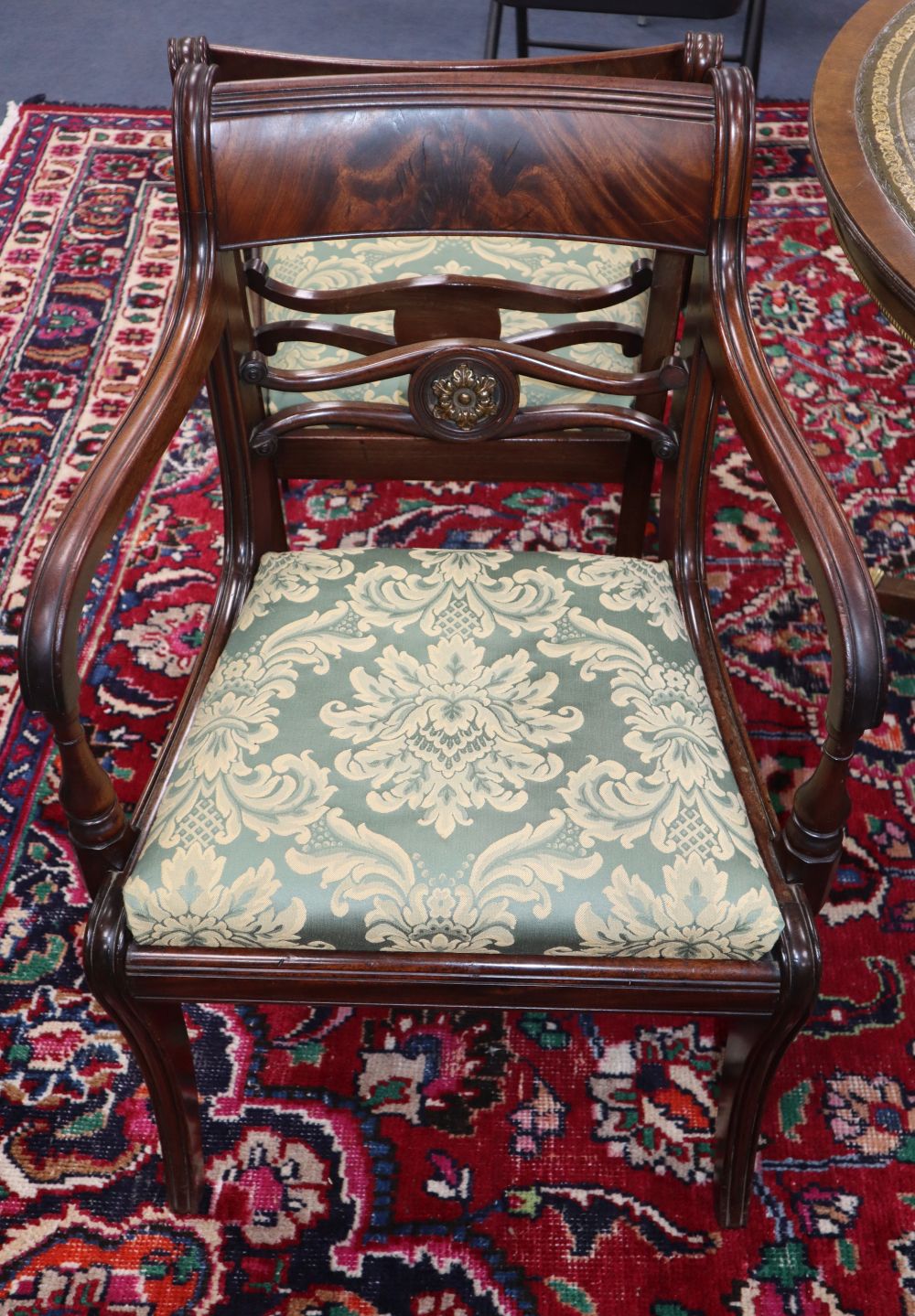 A set of six Regency gilt metal mounted mahogany dining chairs, (two with arms)